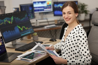 Photo of Stock exchange. Woman working at desk in office