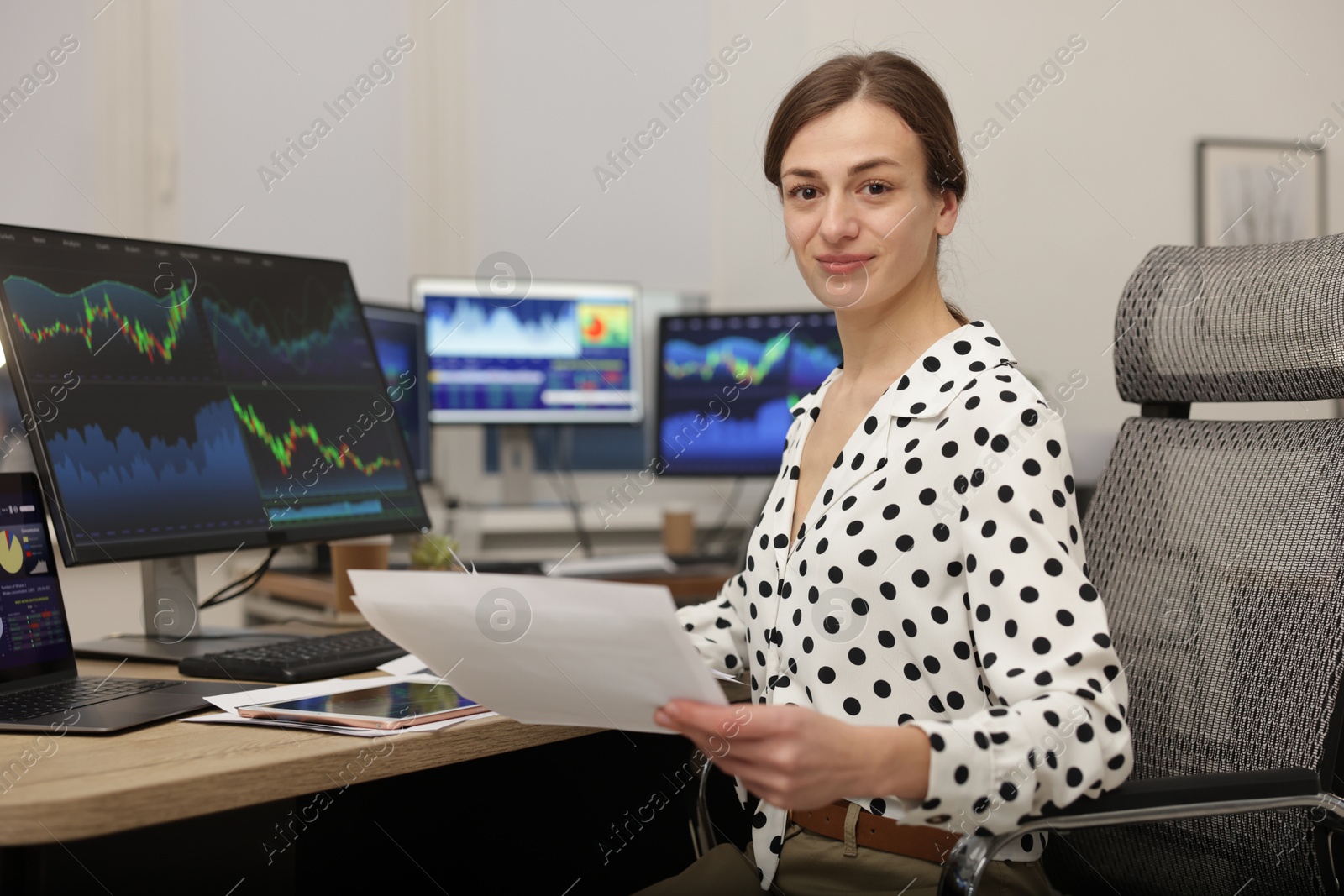 Photo of Stock exchange. Woman working at desk in office