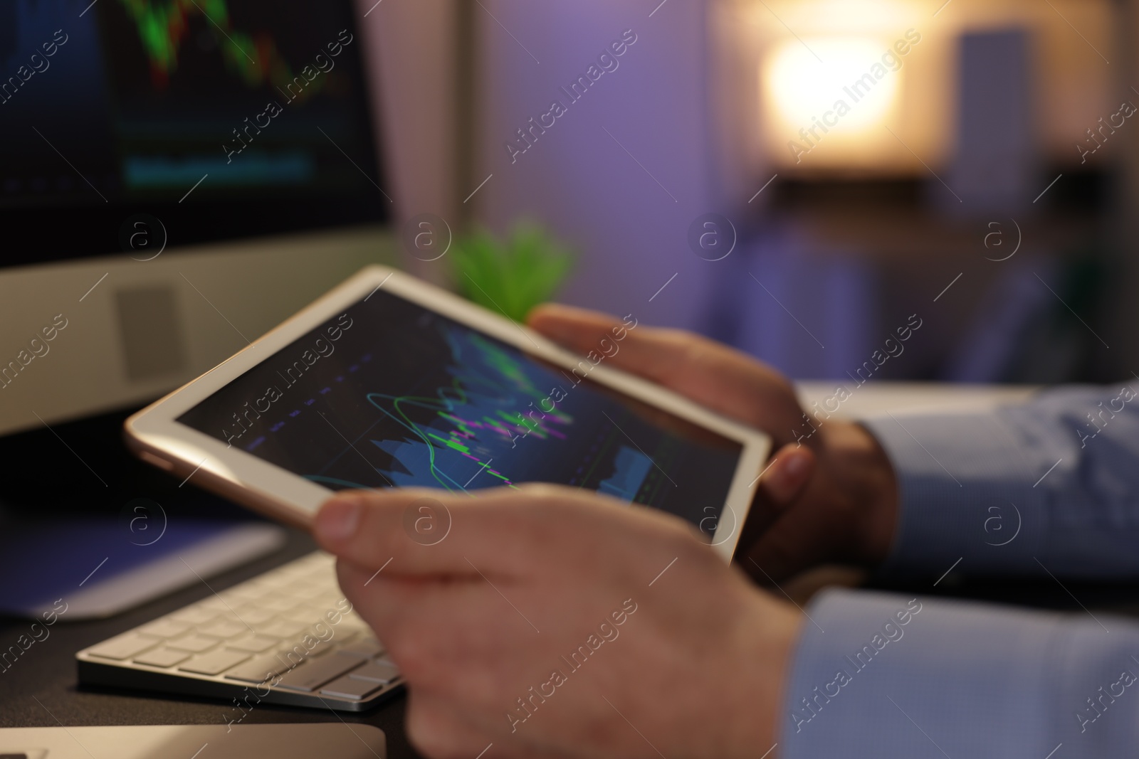 Photo of Stock exchange. Man working in office at night, closeup