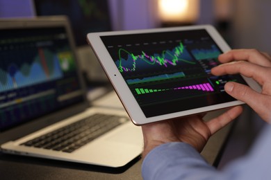 Photo of Stock exchange. Man working in office at night, closeup