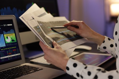 Photo of Stock exchange. Woman working in office at night, closeup