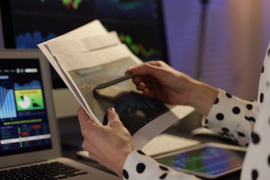 Photo of Stock exchange. Woman working in office at night, closeup