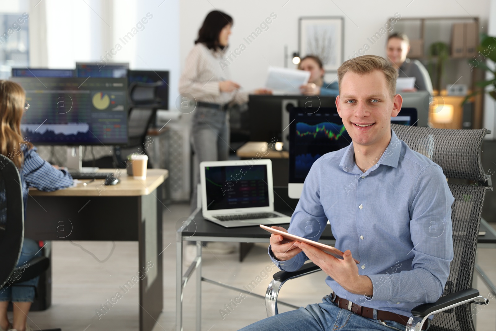 Photo of Stock exchange. Man working at desk in office