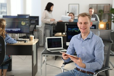 Photo of Stock exchange. Man working at desk in office