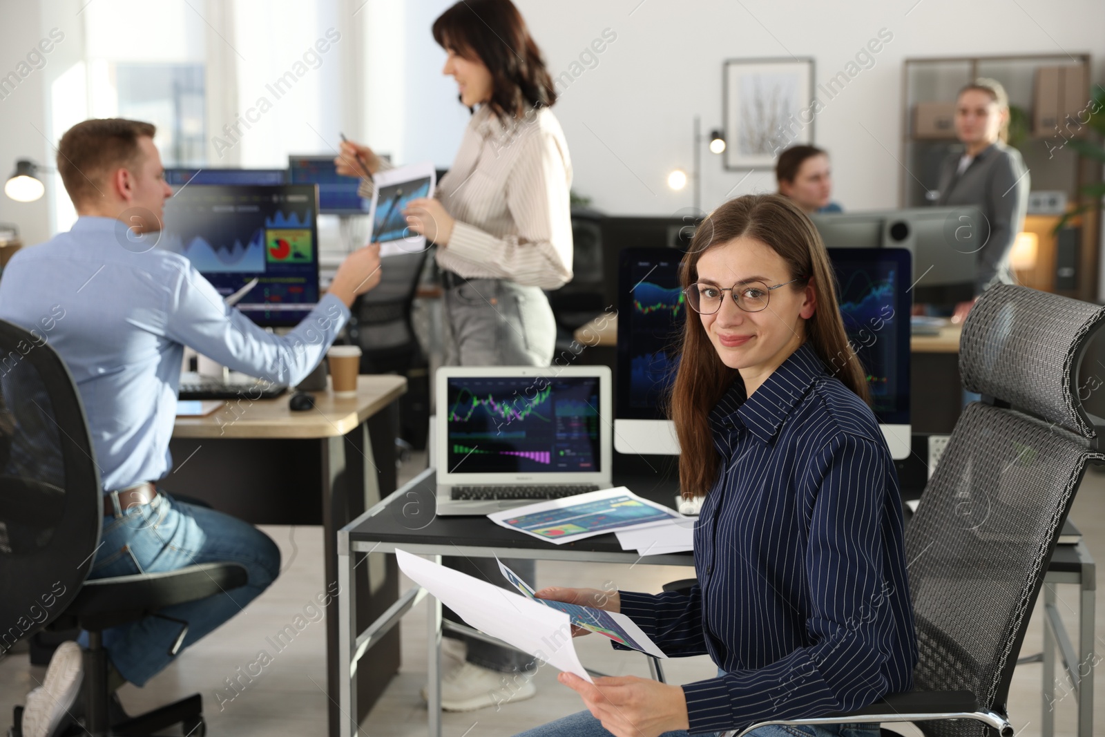 Photo of Stock exchange. Business team working together in office