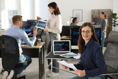 Photo of Stock exchange. Business team working together in office