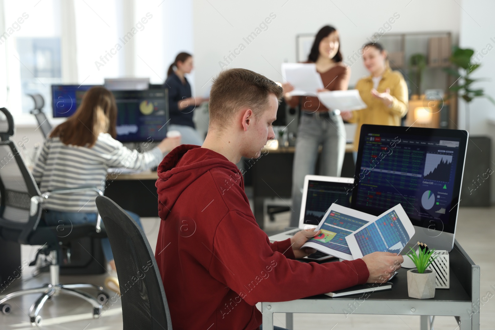 Photo of Stock exchange. Man working at desk in office