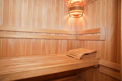 Photo of View of empty wooden sauna with bench