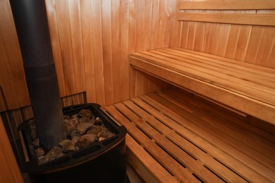 Photo of View of empty wooden sauna with bench