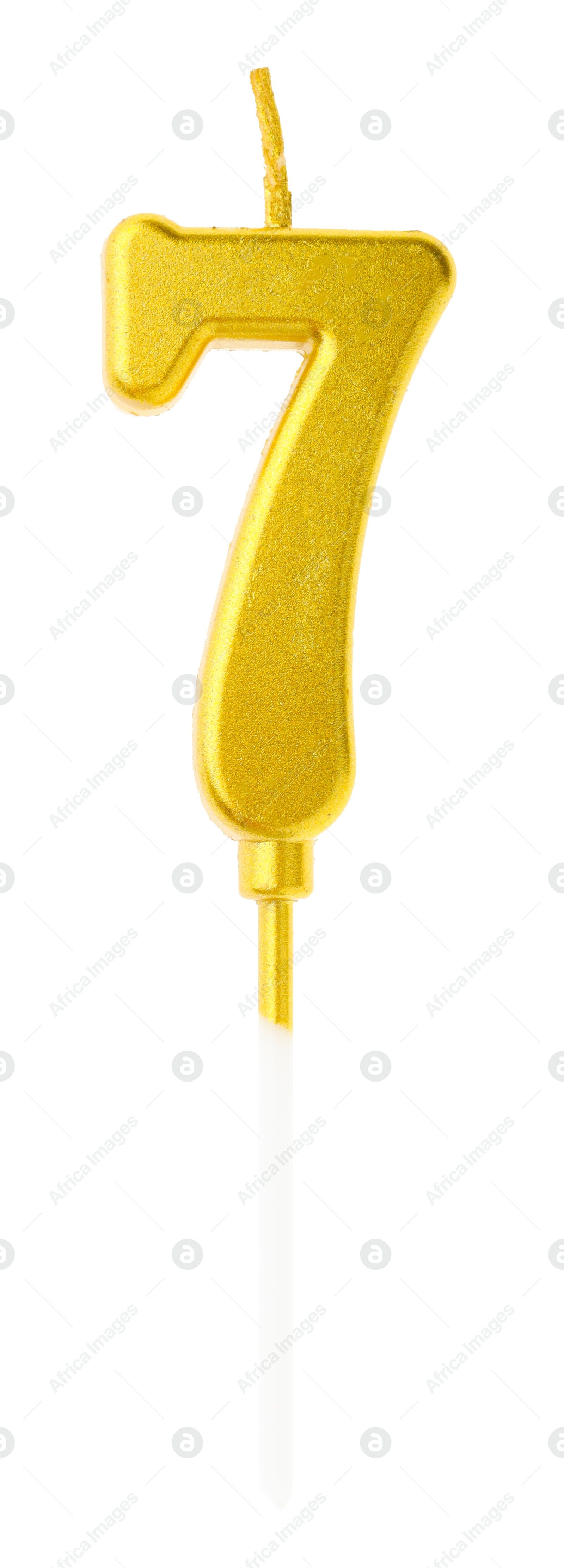 Photo of Golden birthday candle in shape of number 7 isolated on white