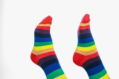 Photo of Woman wearing socks in LGBT colors on white background, closeup