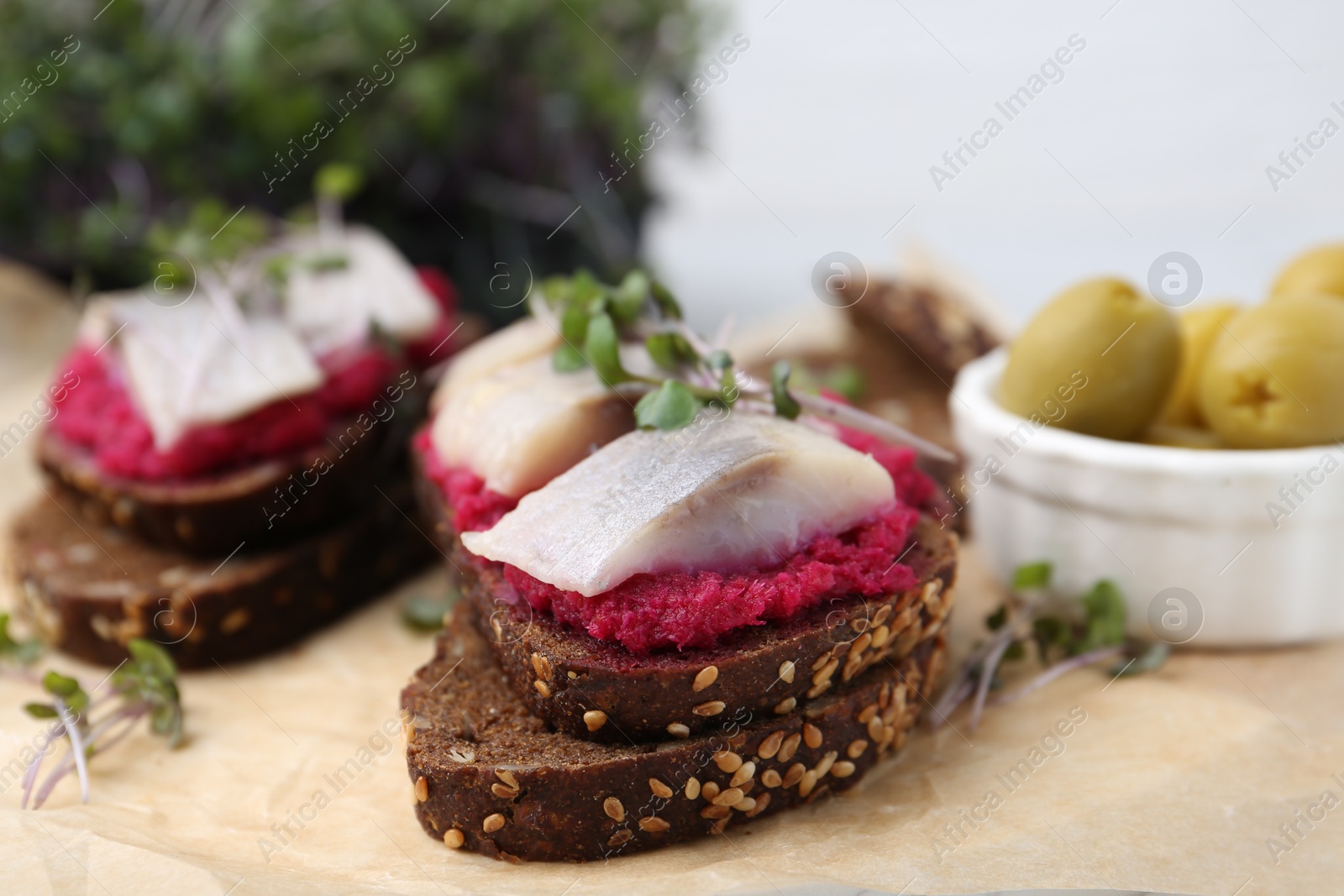 Photo of Tasty sandwiches with herring and horseradish sauce on table, closeup