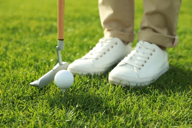 Photo of Person playing golf on green course, closeup