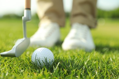 Photo of Person playing golf on green course, closeup