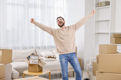 Moving day. Emotional man in his new home