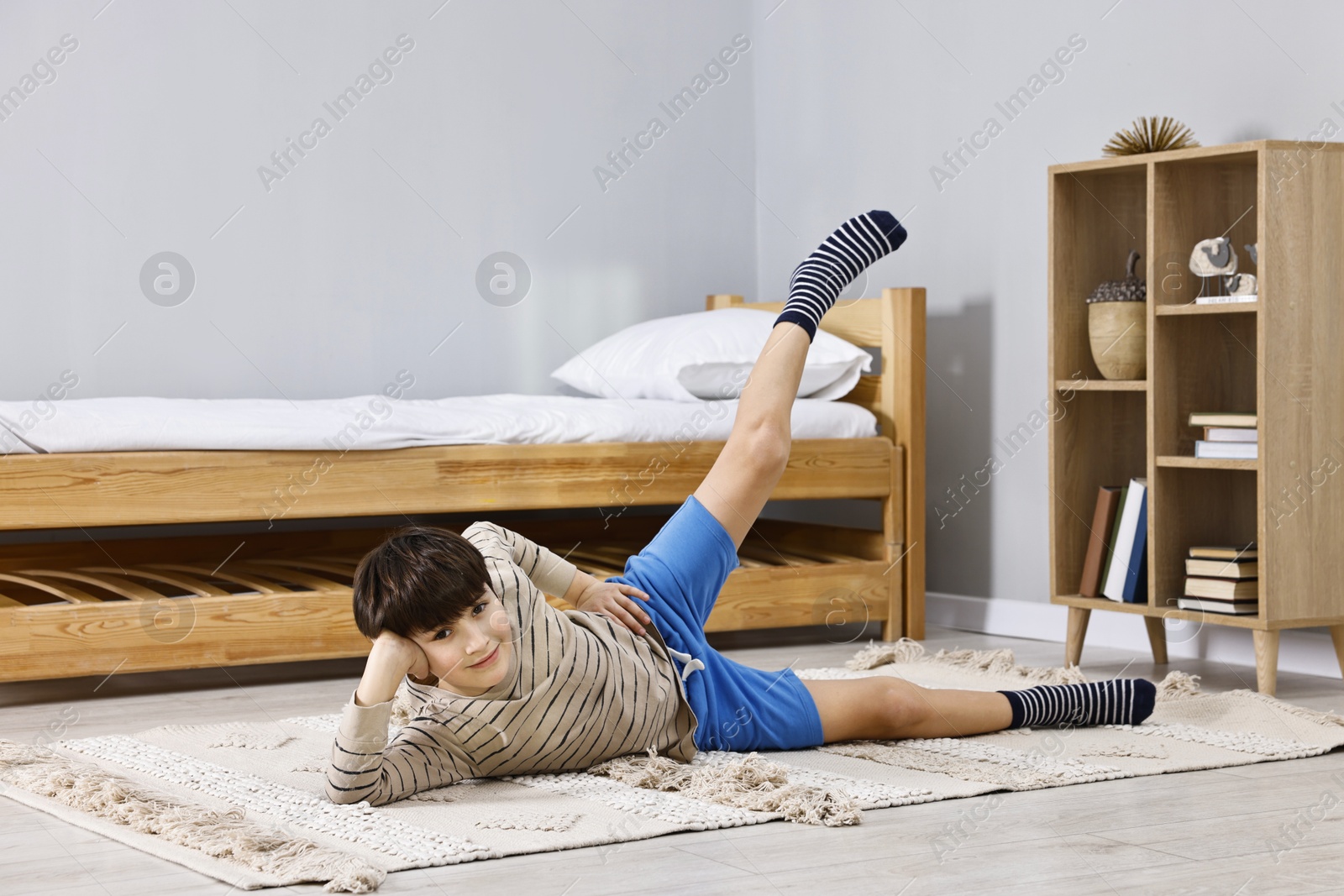 Photo of Little boy exercising at home. Morning routine