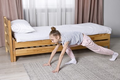 Little girl exercising at home. Morning routine