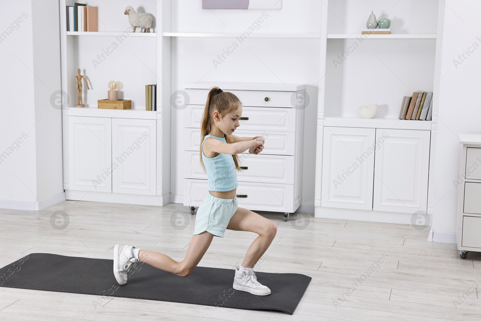 Photo of Little girl exercising at home, space for text. Morning routine