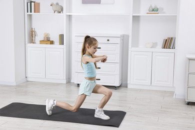 Photo of Little girl exercising at home, space for text. Morning routine