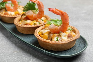 Tartlets with delicious filling on grey table, closeup