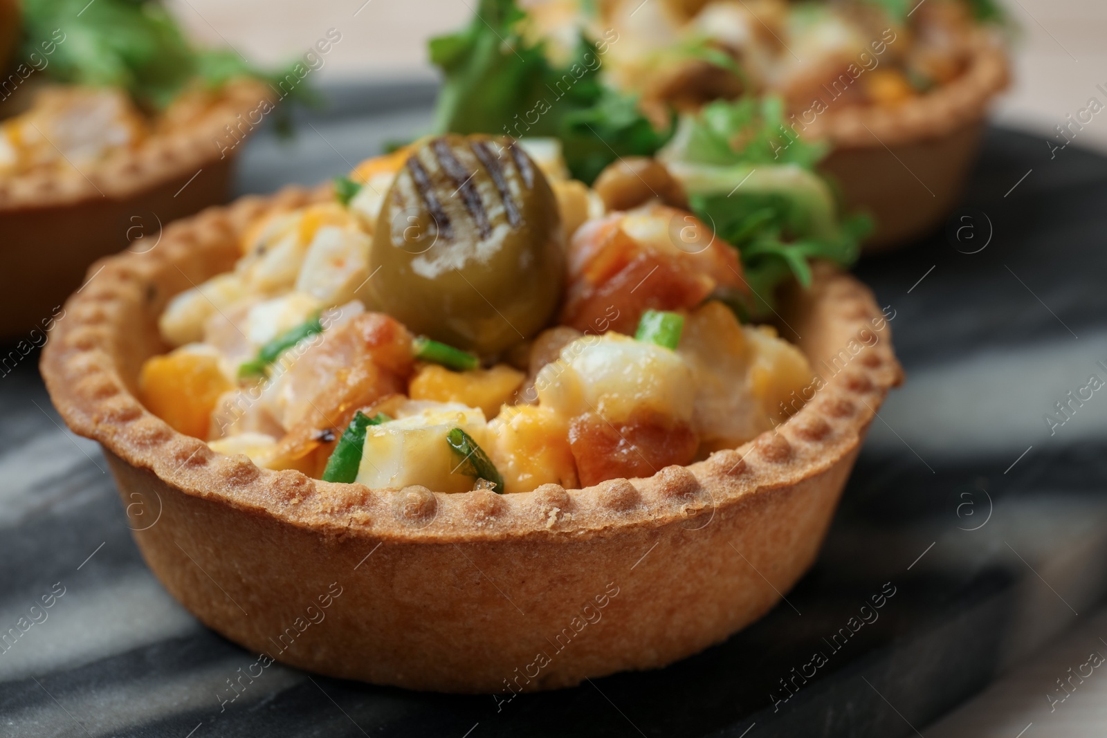 Photo of Tartlets with delicious filling on table, closeup