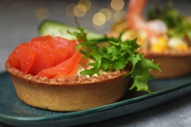 Tartlets with delicious fillings on table, closeup. Bokeh effect