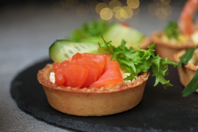 Tartlets with delicious fillings on table, closeup. Bokeh effect