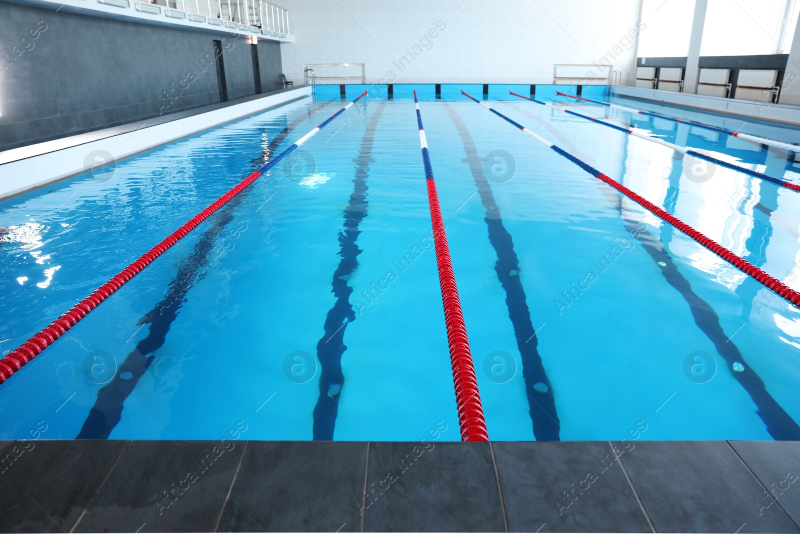 Photo of Swimming pool with clean water and lane dividers indoors