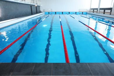 Swimming pool with clean water and lane dividers indoors