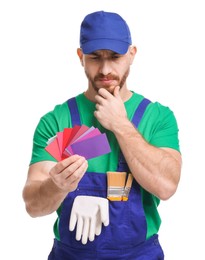 Photo of Pensive painter with color samples on white background