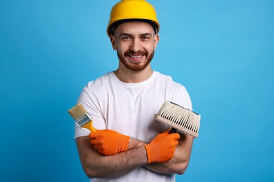 Photo of Man wearing hardhat with tools on blue background