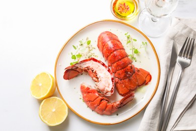 Photo of Delicious tails of boiled lobsters served on white table, flat lay