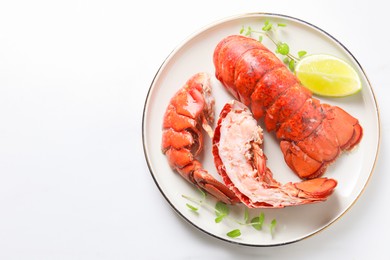 Photo of Delicious tails of boiled lobsters served on white table, top view. Space for text