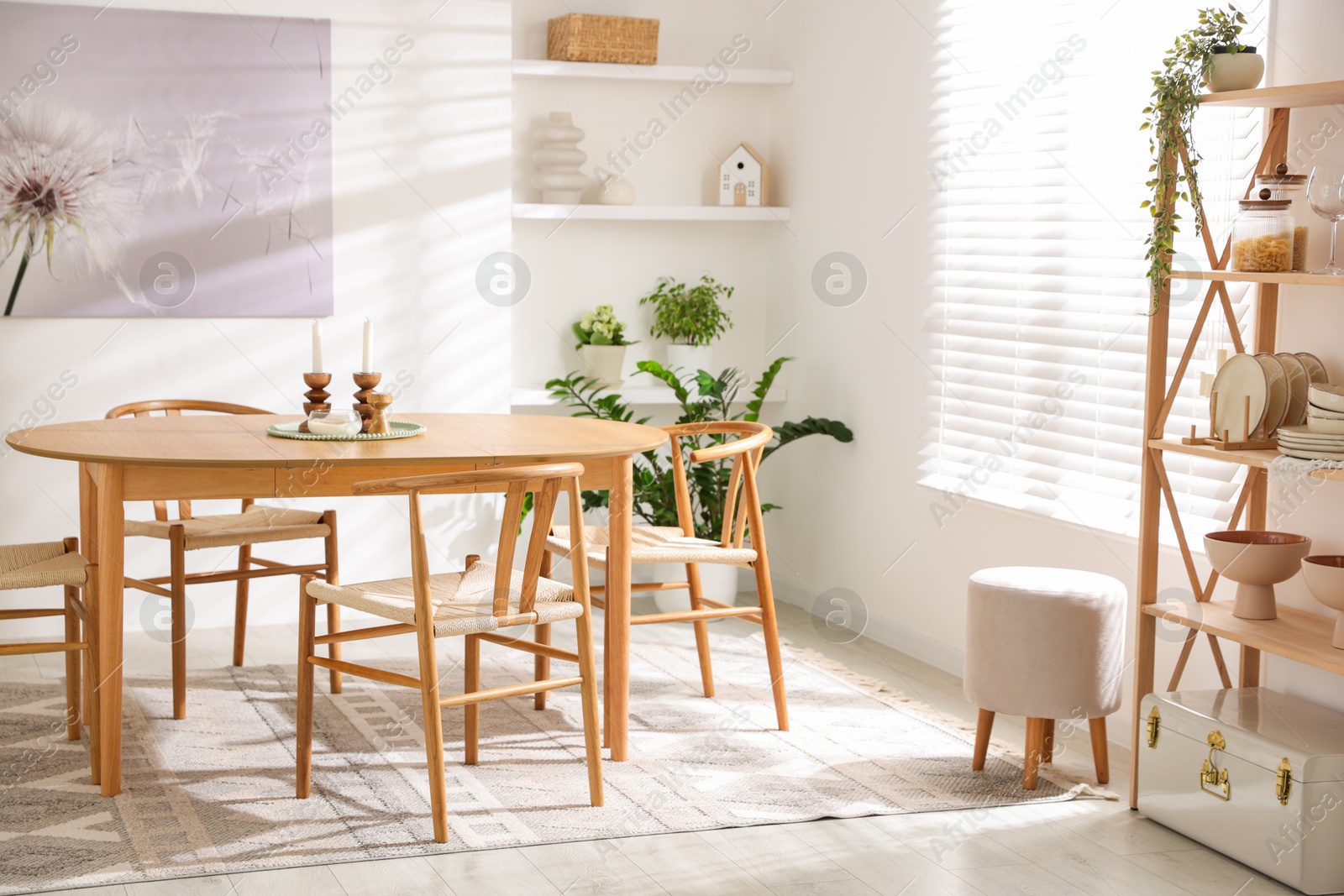 Photo of Stylish room with wooden table, chairs and houseplants. Interior design