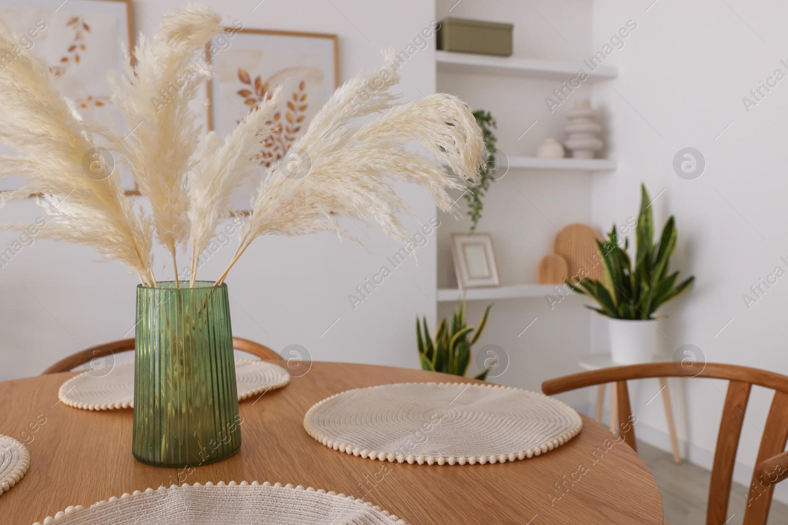 Photo of Stylish wooden table with chairs and decor indoors. Interior design