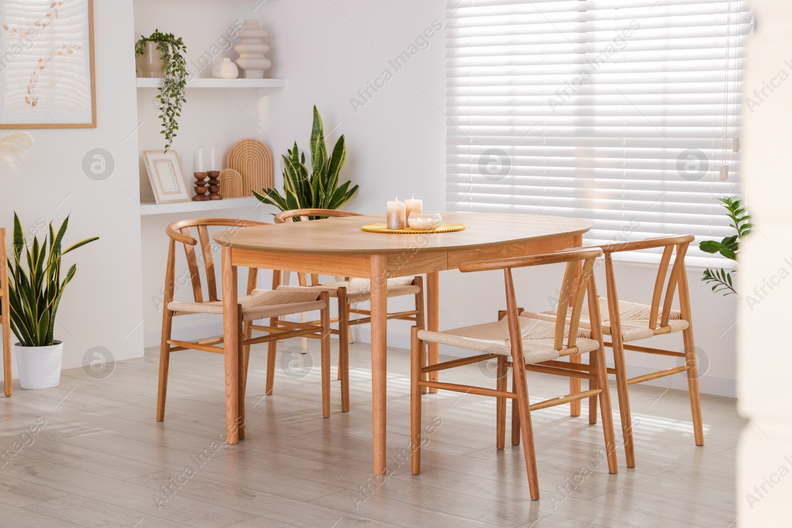 Photo of Stylish wooden table with chairs and decor indoors. Interior design