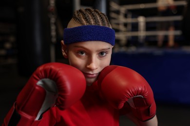 Photo of Boxing. Boy in protective gloves at training center