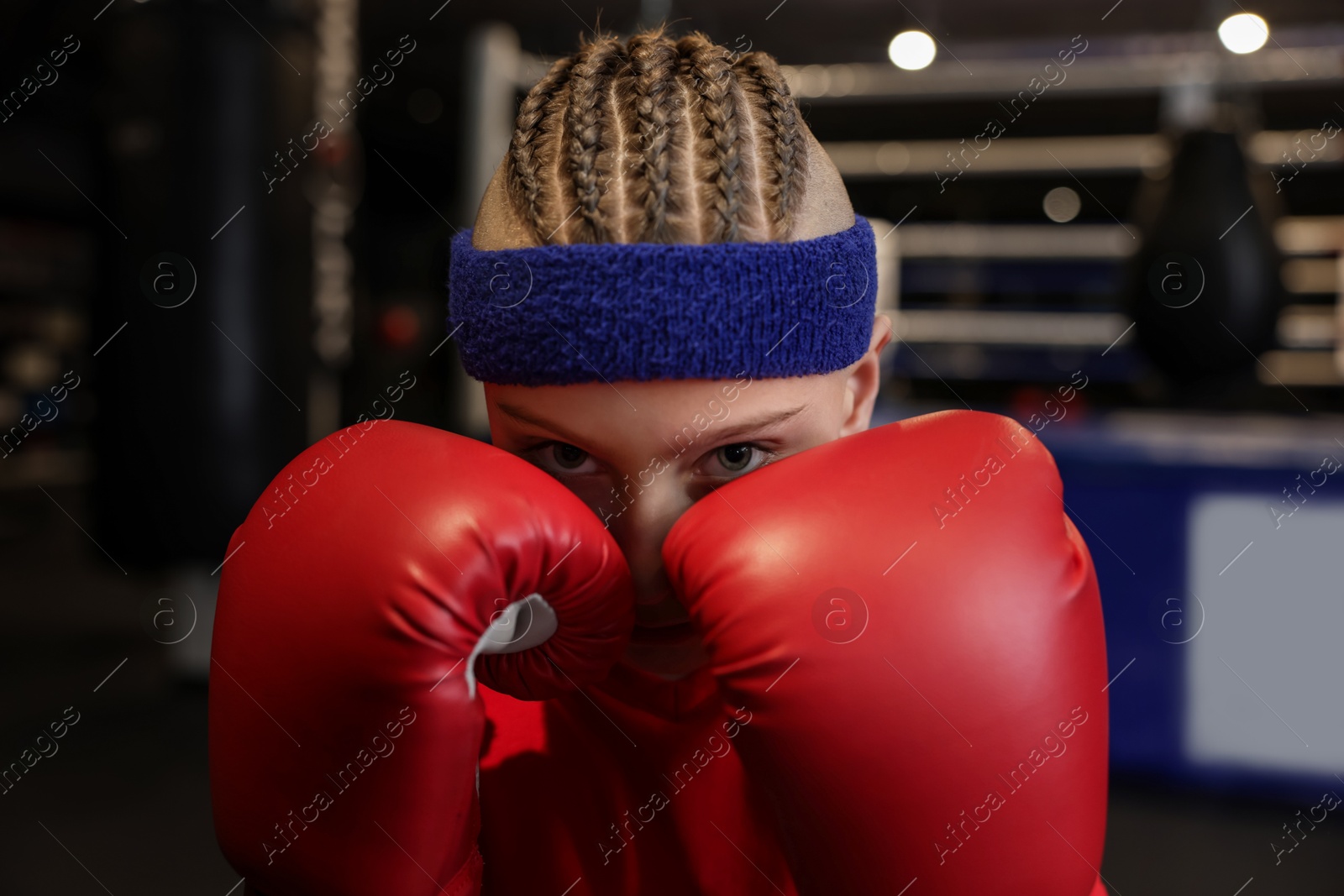 Photo of Boxing. Boy in protective gloves at training center