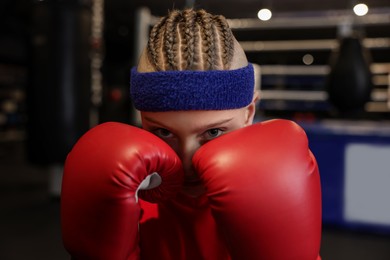 Photo of Boxing. Boy in protective gloves at training center