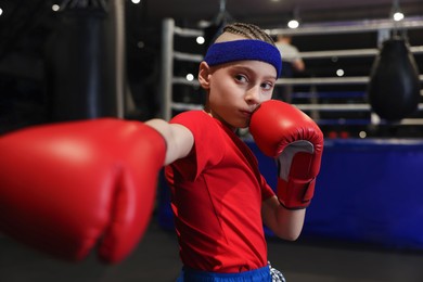 Photo of Boxing. Boy in protective gloves at training center