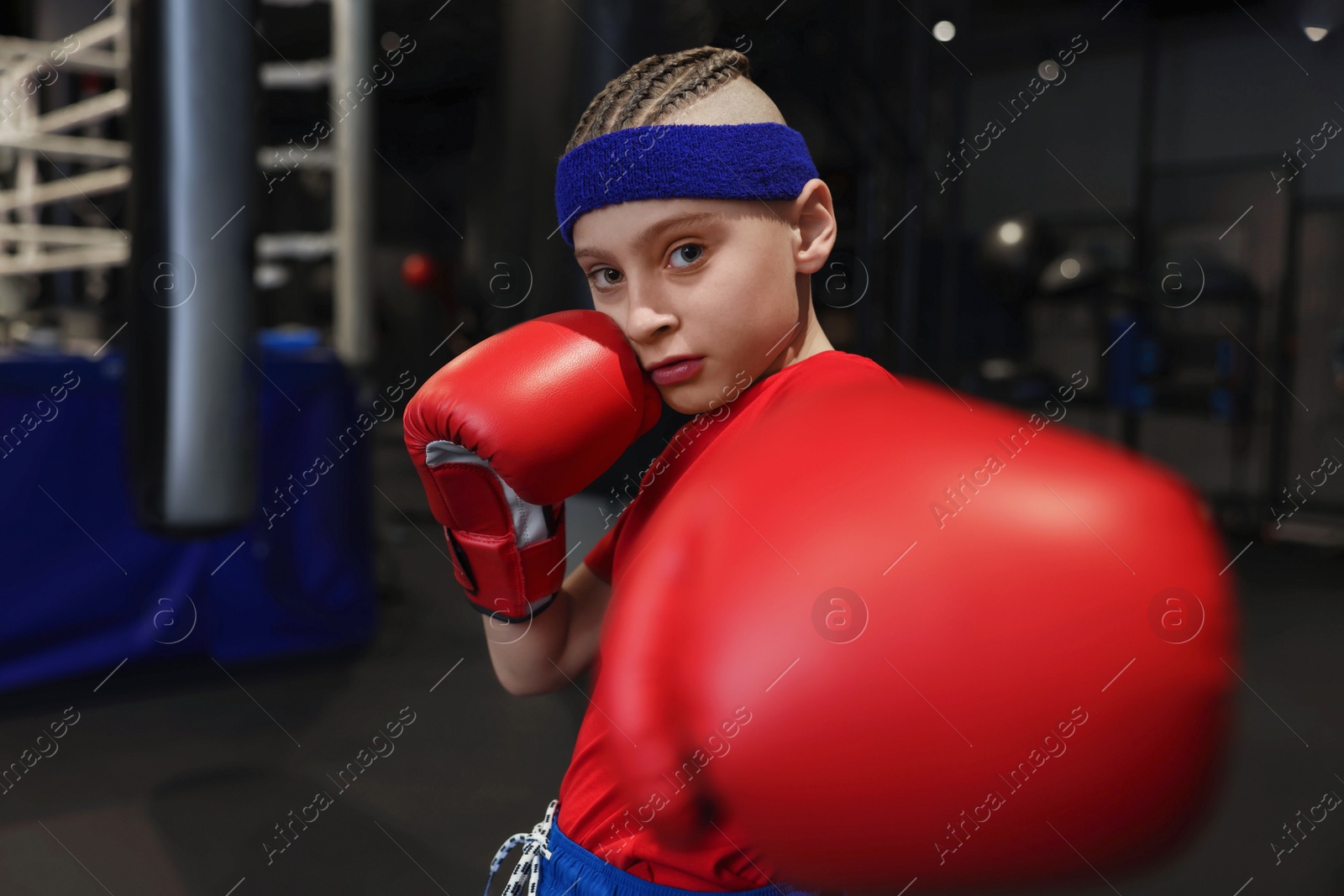 Photo of Boxing. Boy in protective gloves at training center