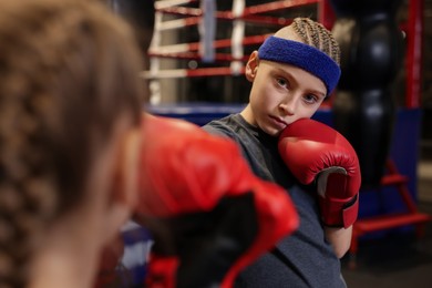 Photo of Children having boxing practice in training center