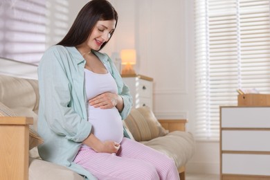 Photo of Beautiful pregnant woman on sofa at home