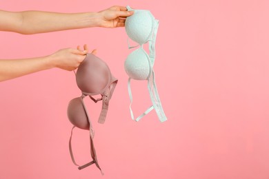 Photo of Woman with beautiful bras on pink background, closeup. Space for text