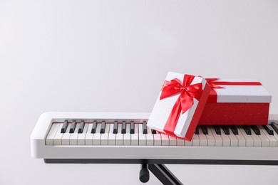 Photo of Christmas gifts on synthesizer against white background