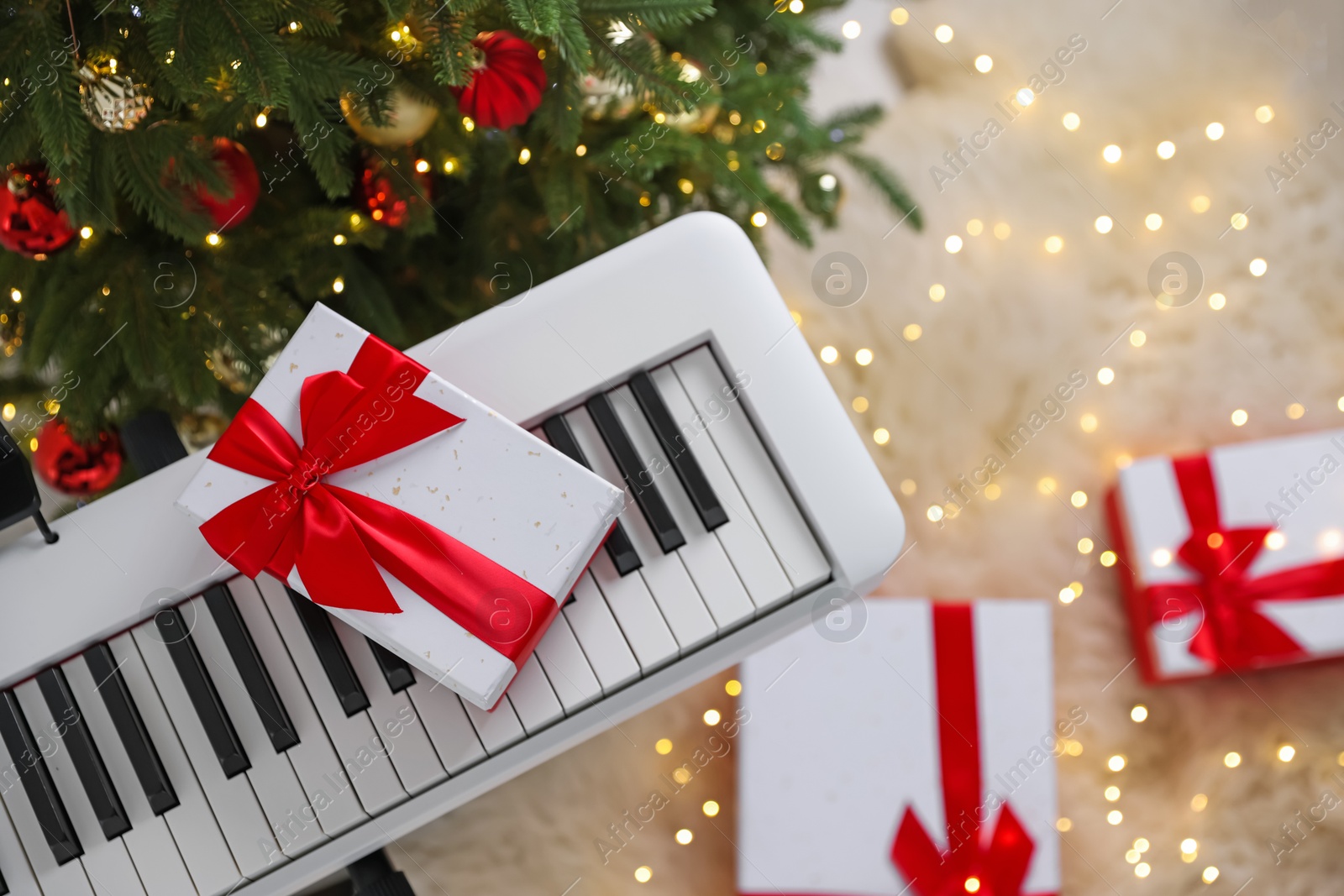 Synthesizer with gift boxes near Christmas tree indoors, top view Photo of Synthesizer with gift boxes near Christmas tree indoors, top view