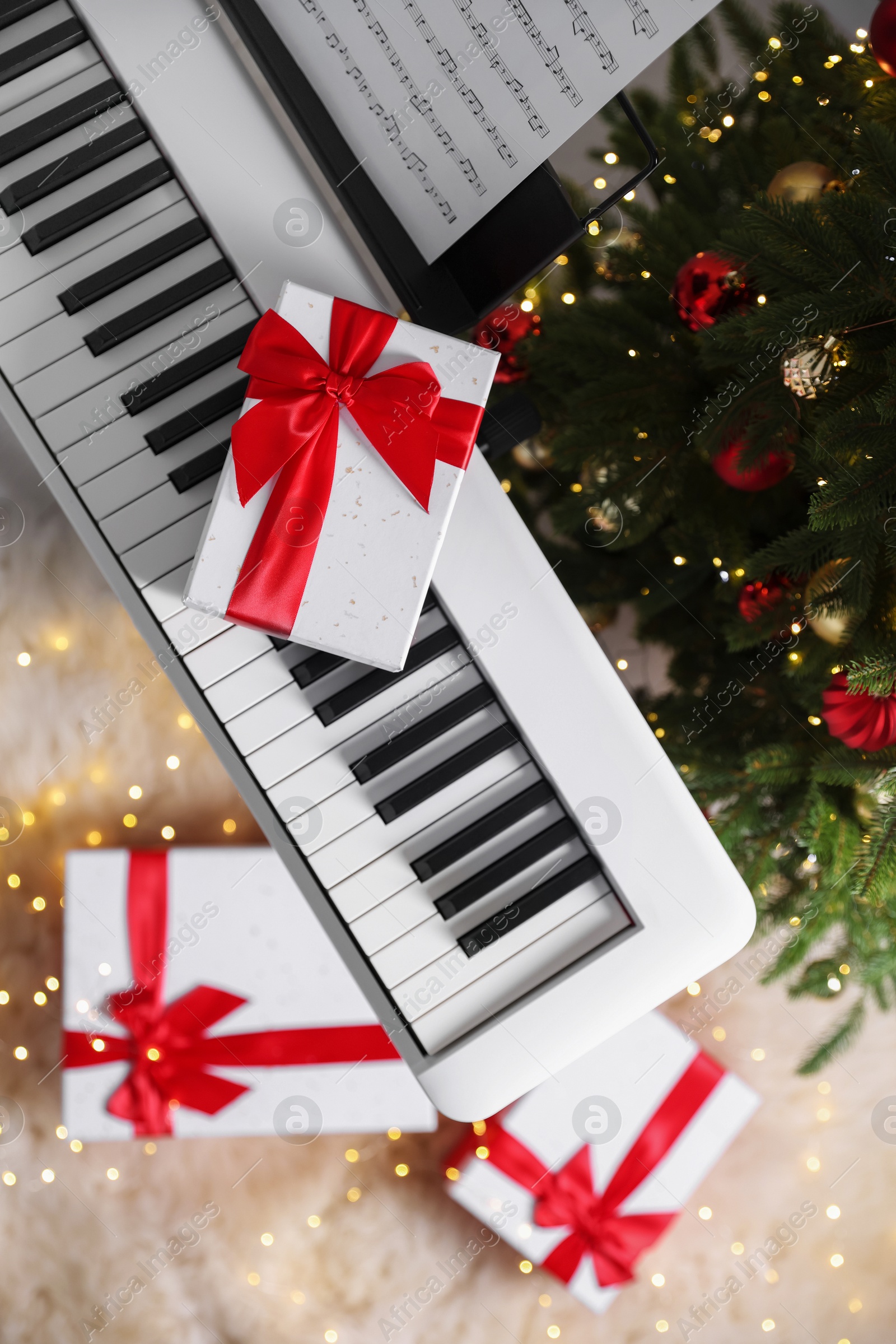 Synthesizer with gift boxes near Christmas tree indoors, top view Photo of Synthesizer with gift boxes near Christmas tree indoors, top view
