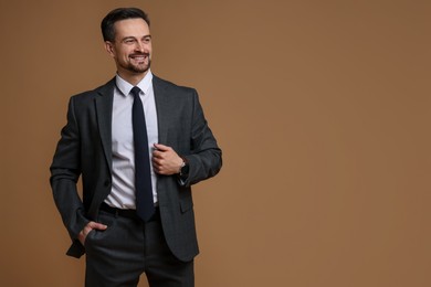 Photo of Handsome man in classic suit on brown background. Space for text