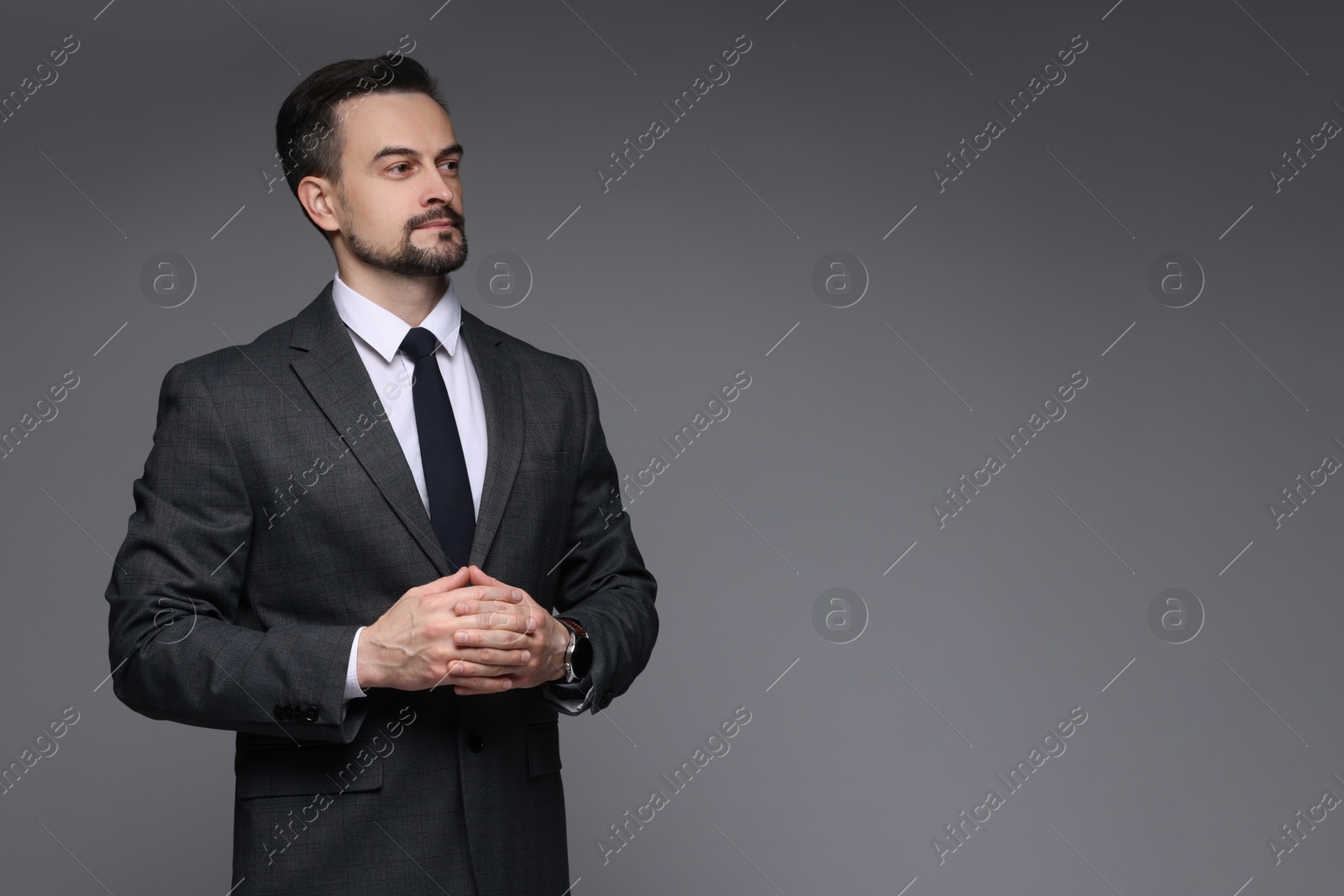 Photo of Confident man in classic suit on grey background