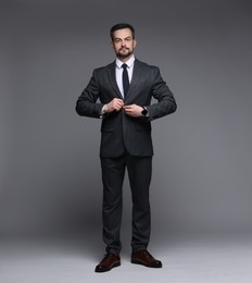 Photo of Confident man in classic suit on grey background